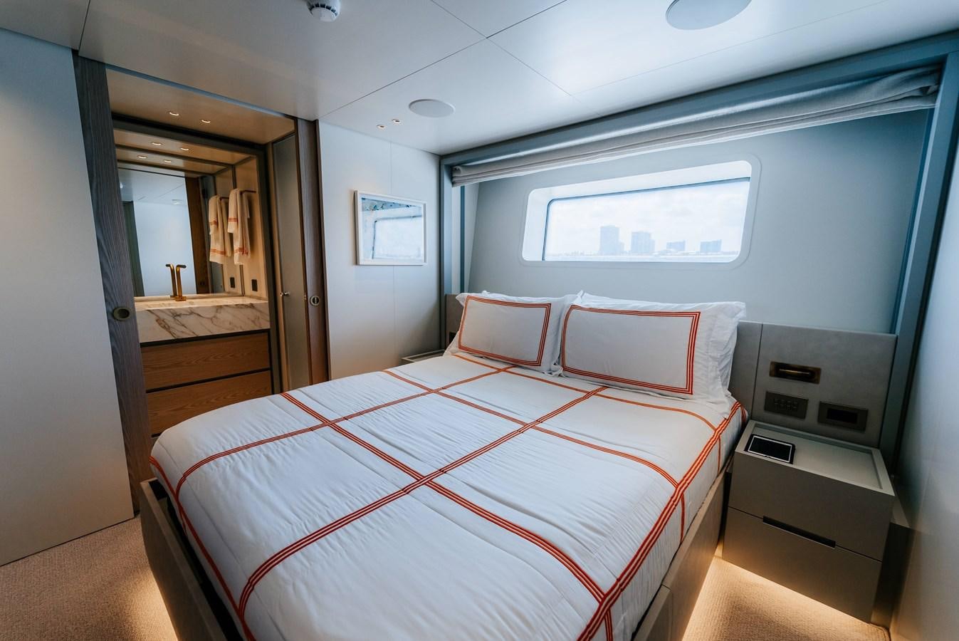 a room with a bed and a mirror aboard PEARL Yacht for Sale