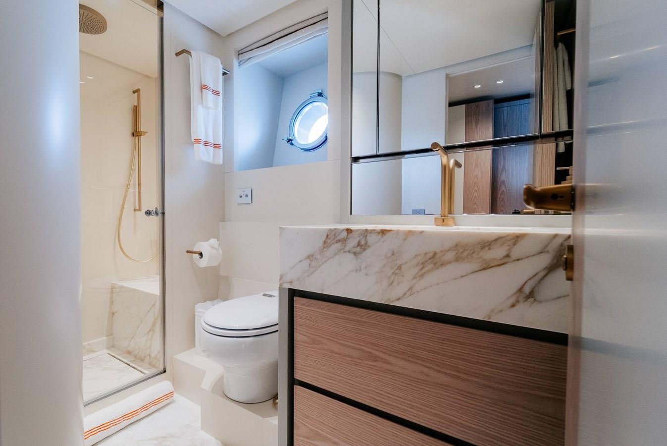 a bathroom with a tub sink and toilet aboard PEARL Yacht for Sale