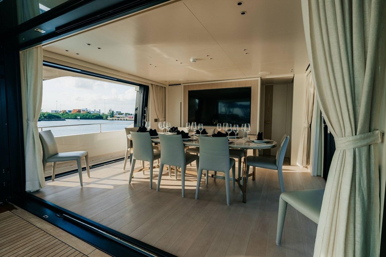 a room with a table and chairs aboard PEARL Yacht for Sale