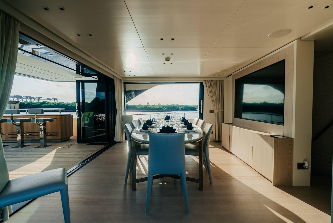 a room with a table and chairs aboard PEARL Yacht for Sale