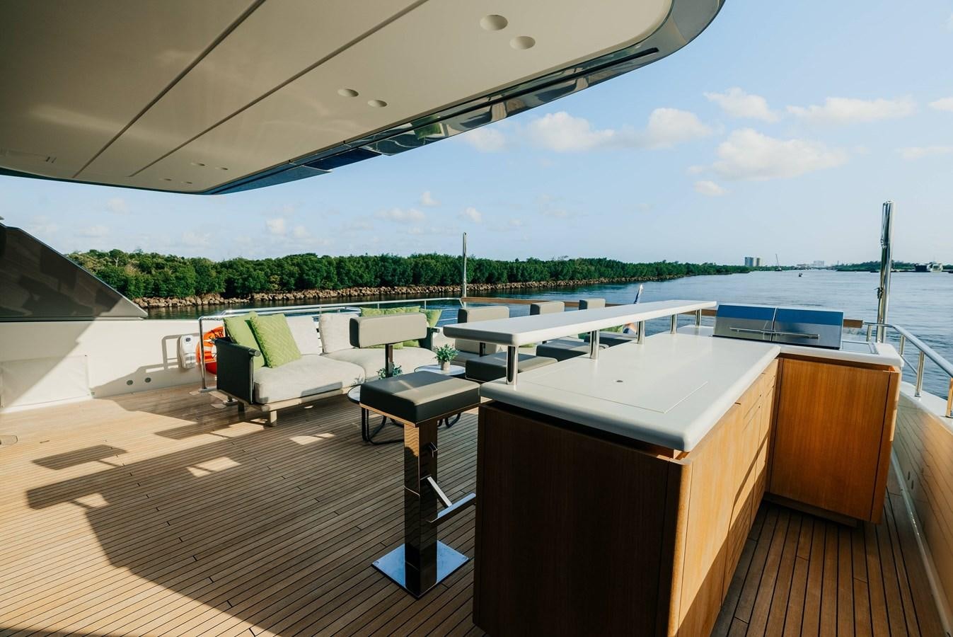 a deck with a view of a body of water and a large boat aboard PEARL Yacht for Sale