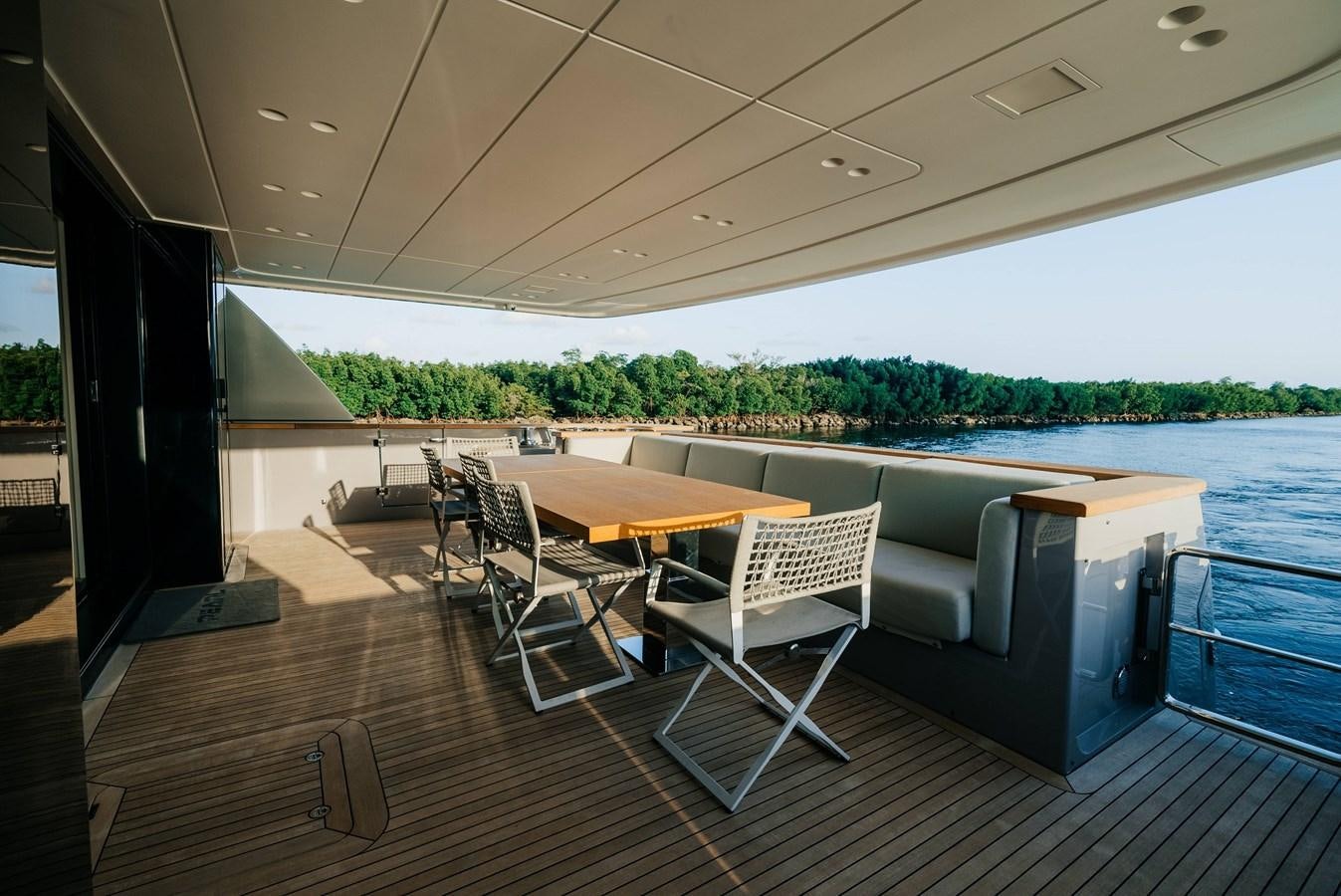 a deck with chairs and tables aboard PEARL Yacht for Sale