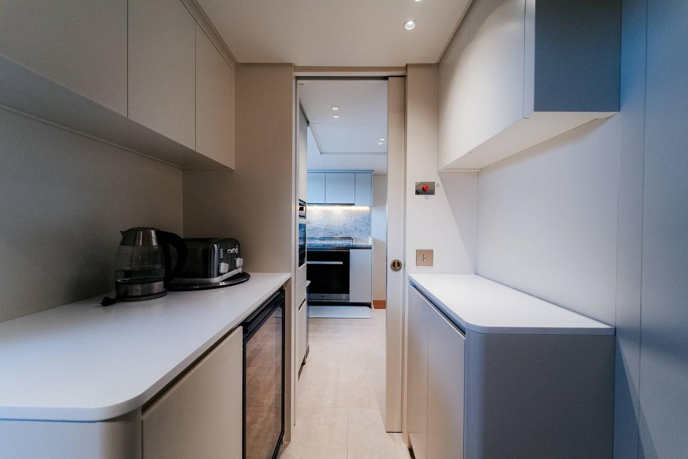 a kitchen with a stove and cabinets aboard PEARL Yacht for Sale