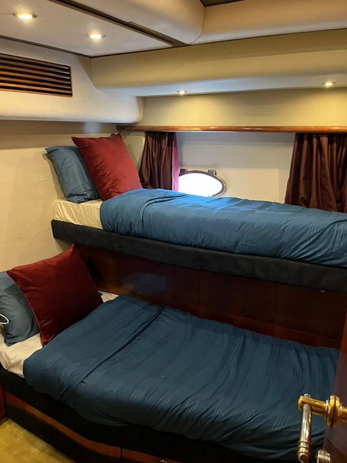 a bed with a blue bed spread aboard ARTENGO Yacht for Sale