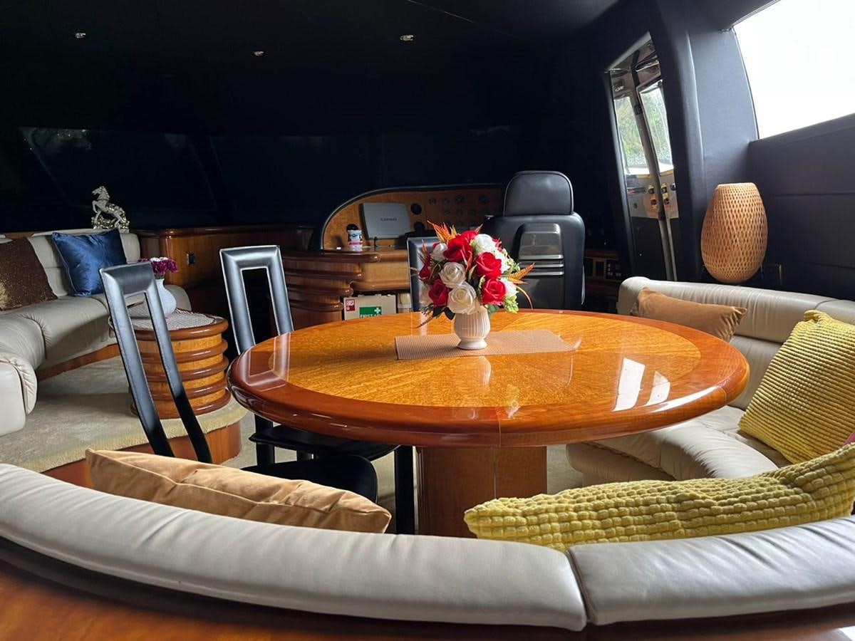 a living room with a table and couches aboard ARTENGO Yacht for Sale