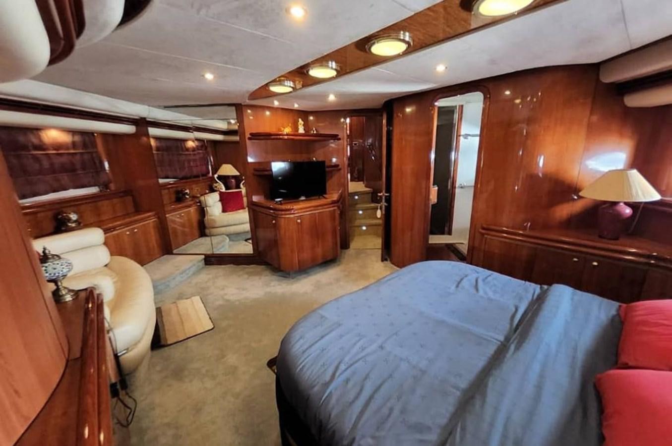 a room with a bed and a fireplace aboard ARTENGO Yacht for Sale