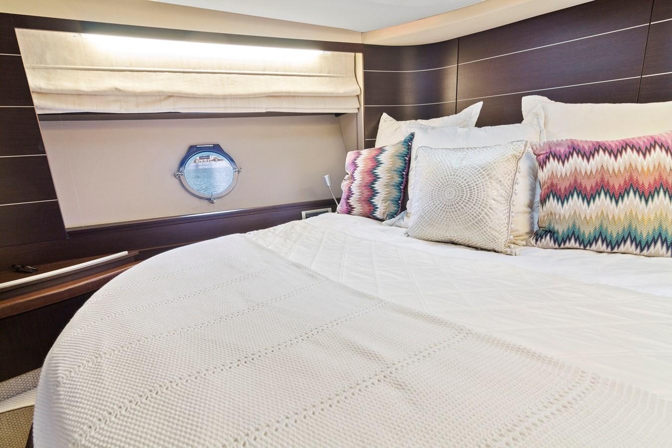 a bed with a white sheet and pillows aboard BLIND SQUIRREL Yacht for Sale