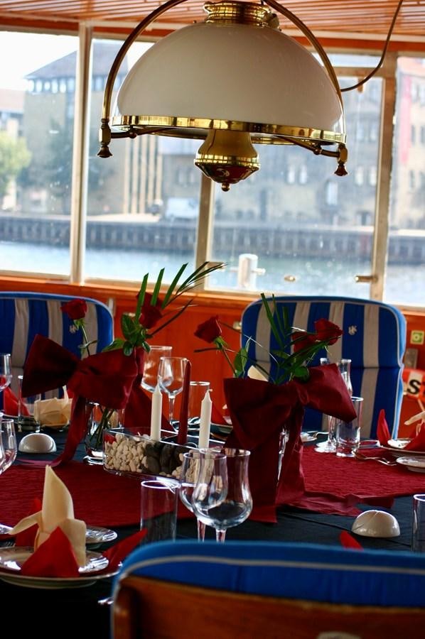 a table with glasses and a vase with flowers on it aboard SANSSOUCI STAR Yacht for Sale