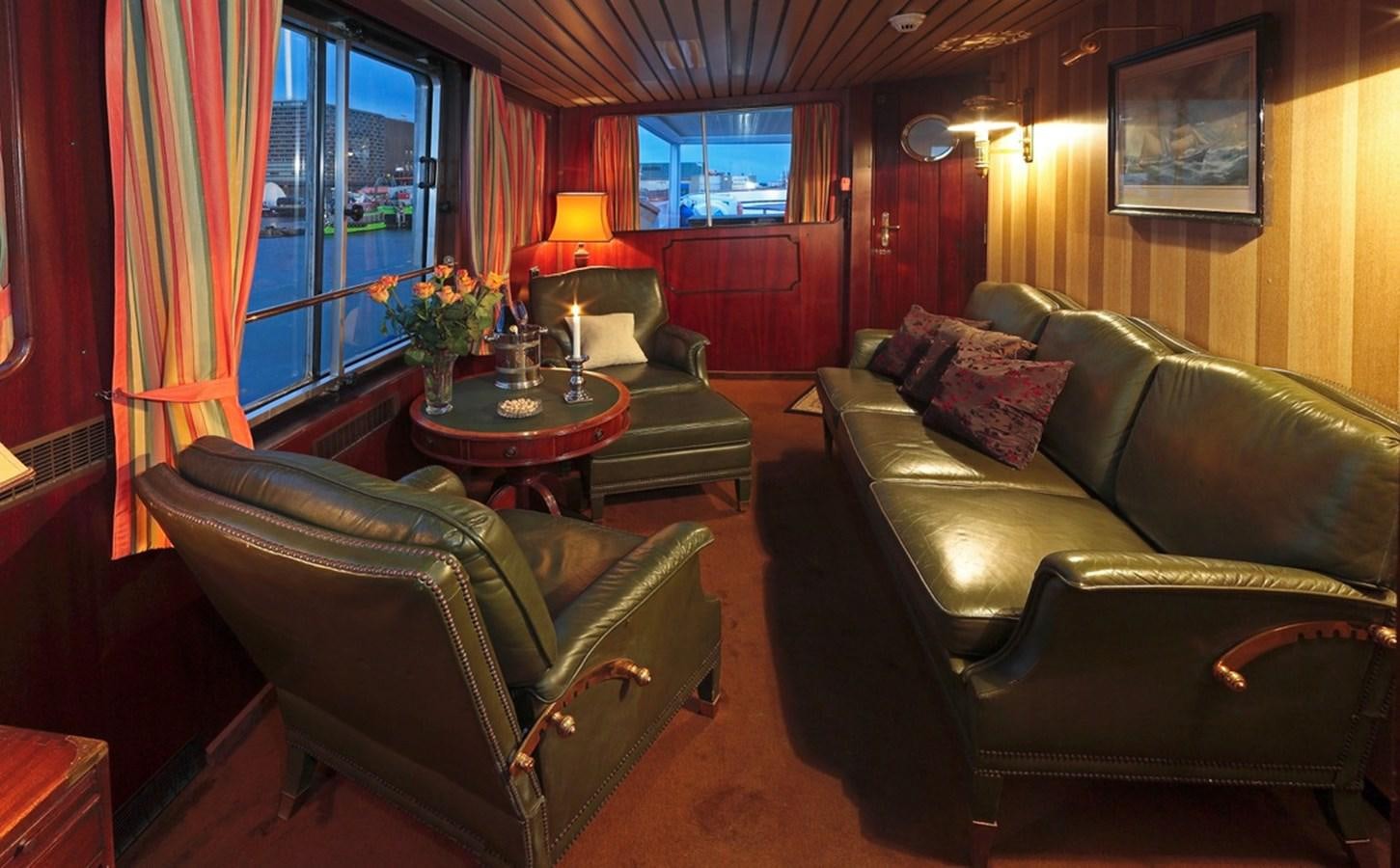 a living room with leather couches and a coffee table aboard SANSSOUCI STAR Yacht for Sale