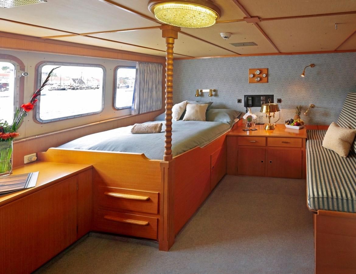 a bedroom with a bed and desk aboard SANSSOUCI STAR Yacht for Sale