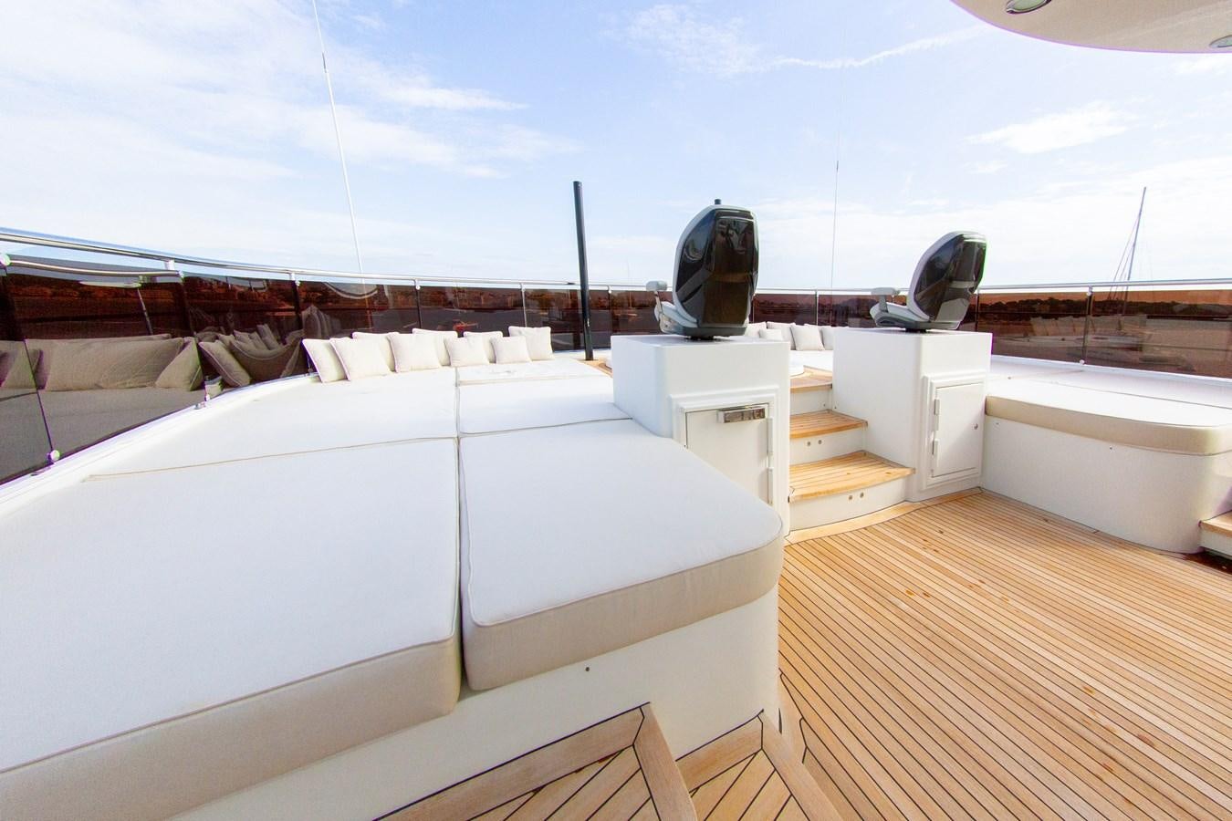 a room with a large bed and a large black chair on the roof aboard DARLING Yacht for Sale