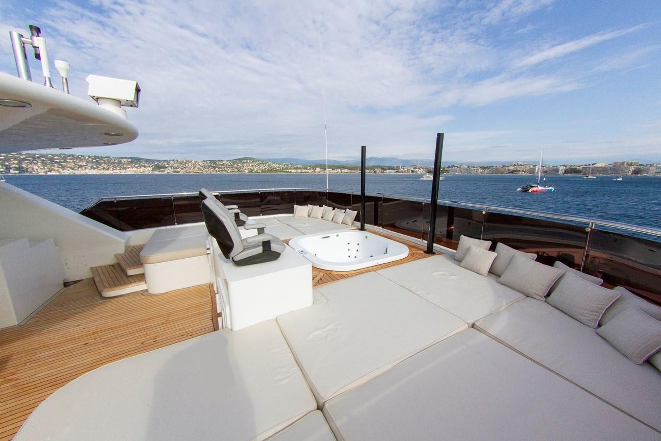 a room with a view of the ocean and a large white boat aboard DARLING Yacht for Sale