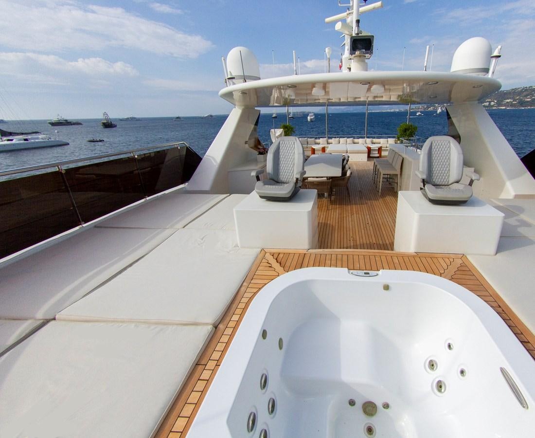 a deck of a boat and a large ship on the water aboard DARLING Yacht for Sale
