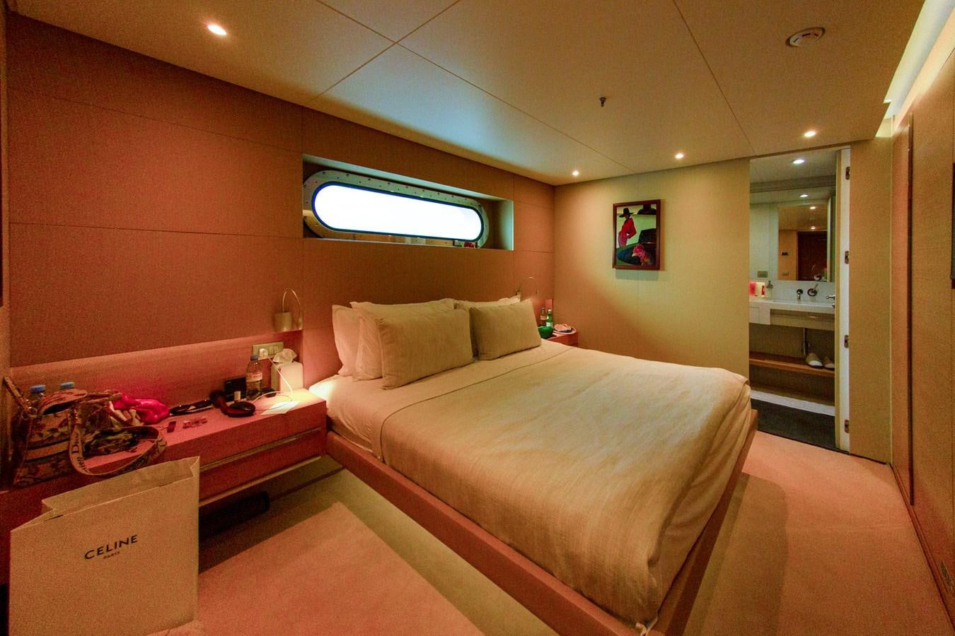 a bedroom with a bed and a mirror aboard DARLING Yacht for Sale