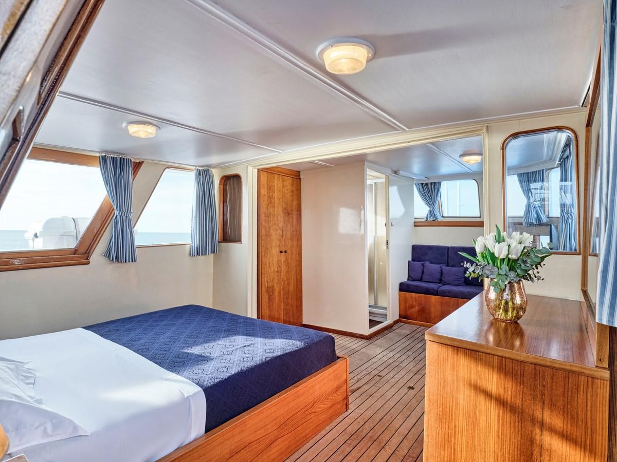 a bedroom with a bed and a desk aboard MIDNIGHT SUN Yacht for Sale