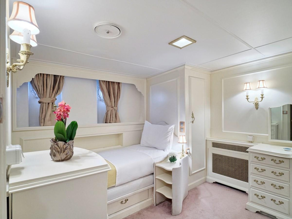 a white living room with a white couch and a white table aboard MIDNIGHT SUN Yacht for Sale