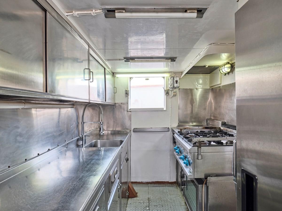 a kitchen with stainless steel appliances aboard MIDNIGHT SUN Yacht for Sale