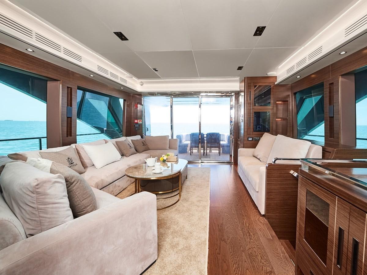 a living room with a large window aboard DIVA RITA Yacht for Sale