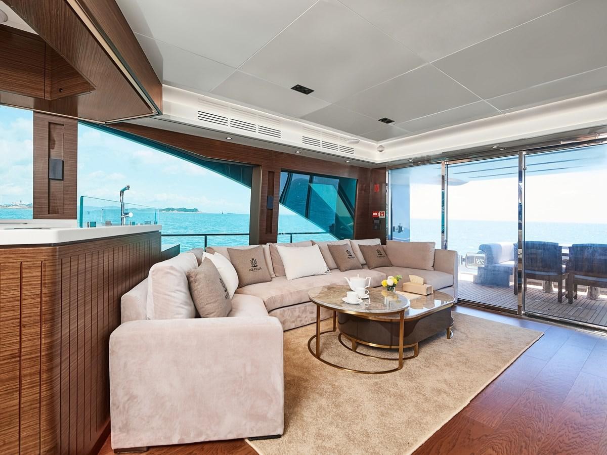 a living room with a large window aboard DIVA RITA Yacht for Sale