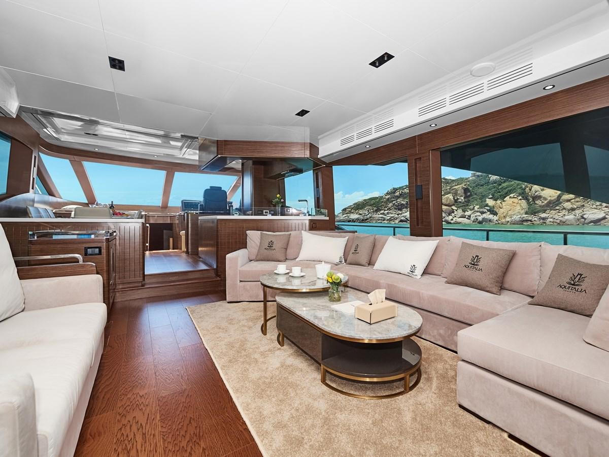 a living room with a large window aboard DIVA RITA Yacht for Sale
