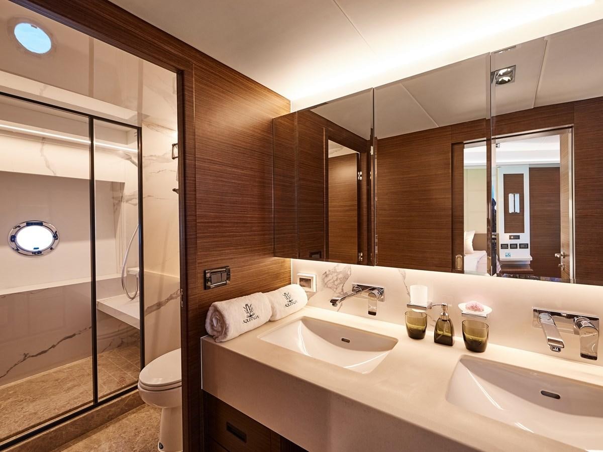 a bathroom with a glass shower aboard DIVA RITA Yacht for Sale