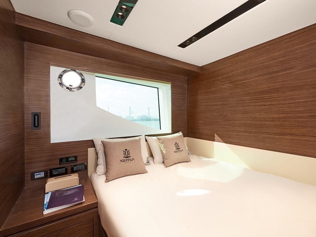 a room with a bed and a window aboard DIVA RITA Yacht for Sale
