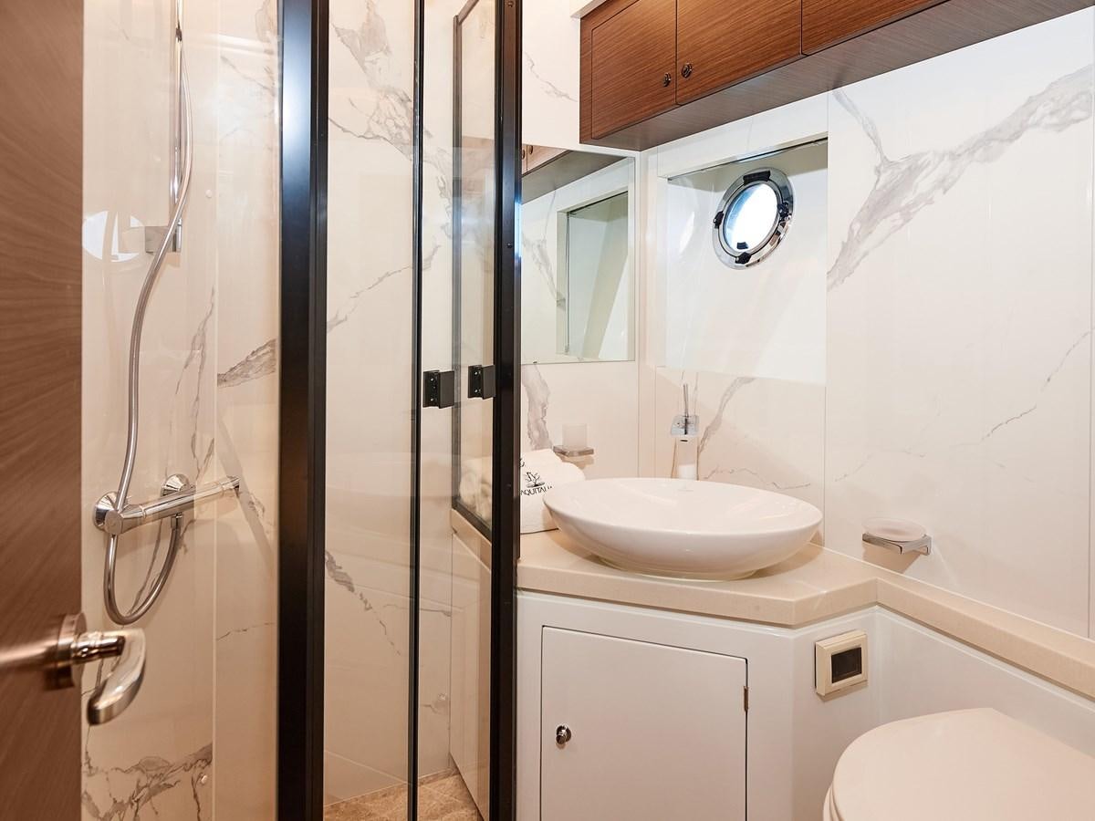 a bathroom with a sink and shower aboard DIVA RITA Yacht for Sale