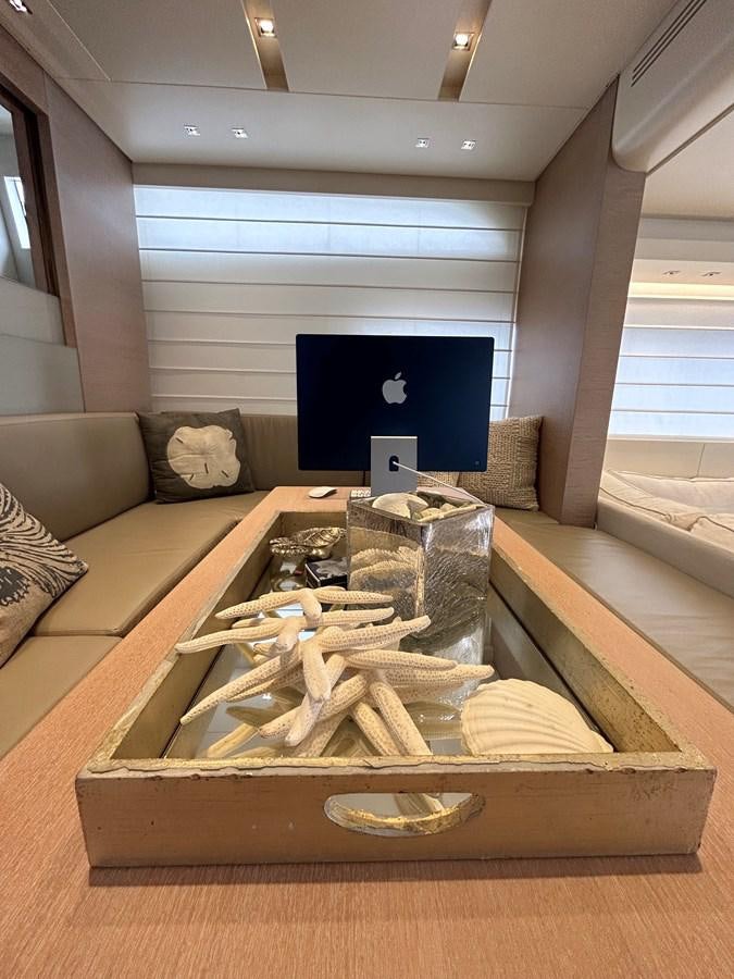 a wood box with a screen and a couch in the background aboard KIND OF BLUE Yacht for Sale