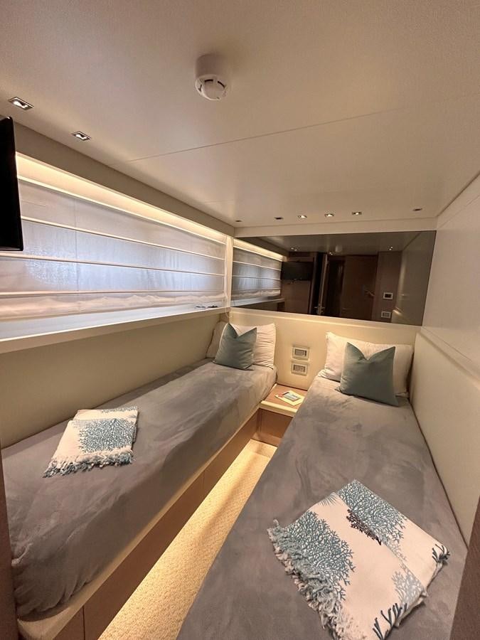 a room with a bed and a mirror aboard KIND OF BLUE Yacht for Sale