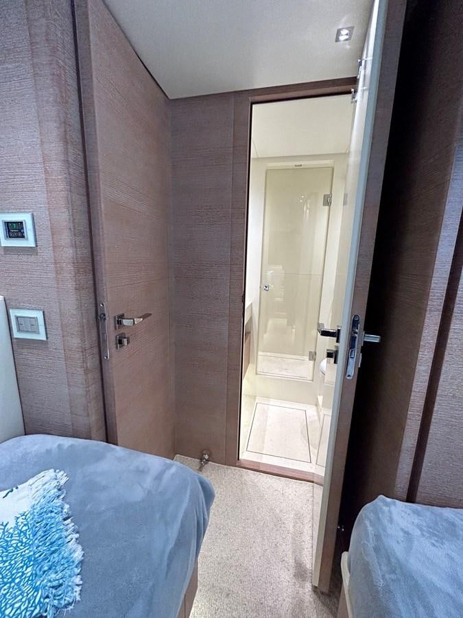 a room with a bed and a door aboard KIND OF BLUE Yacht for Sale