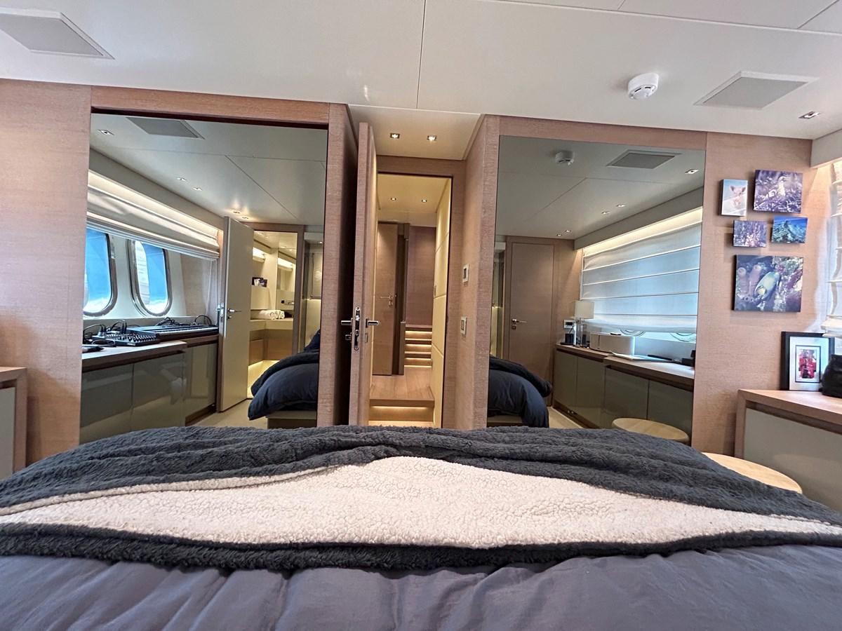 a bedroom with a bed and a desk aboard KIND OF BLUE Yacht for Sale