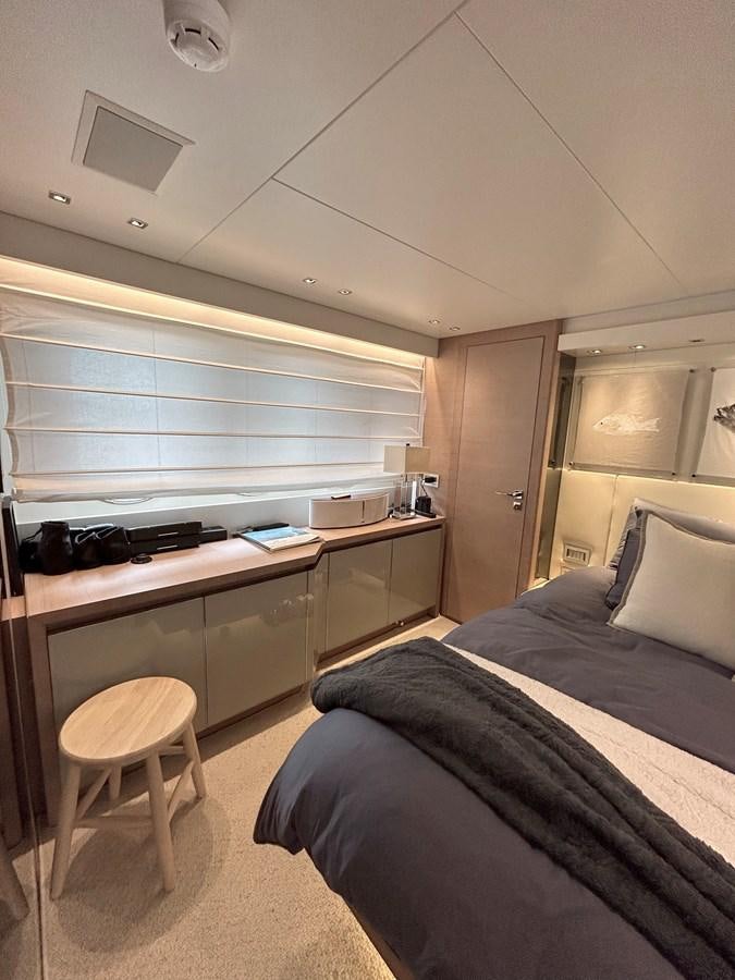 a bedroom with a bed and desk aboard KIND OF BLUE Yacht for Sale