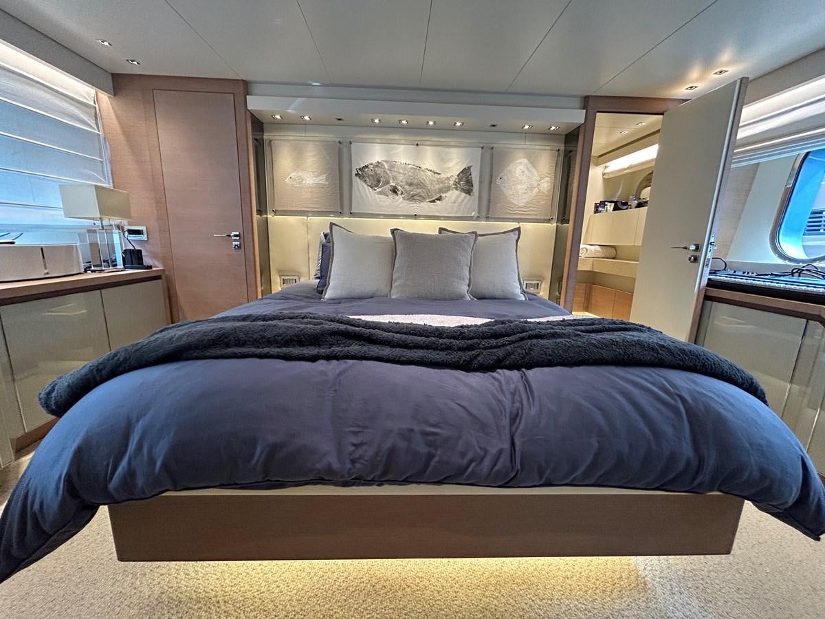 a bed with a black comforter aboard KIND OF BLUE Yacht for Sale