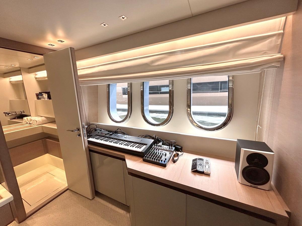 a computer desk with a computer and speakers aboard KIND OF BLUE Yacht for Sale