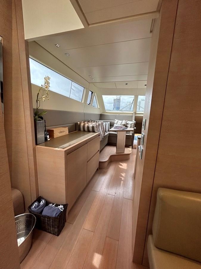 a room with a wood floor and a couch and a window aboard KIND OF BLUE Yacht for Sale