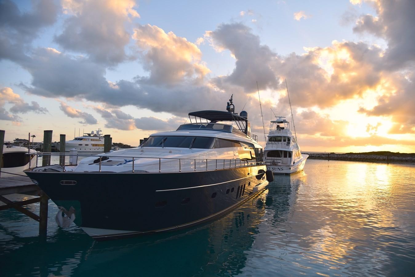a couple of boats sit in a harbor aboard KIND OF BLUE Yacht for Sale