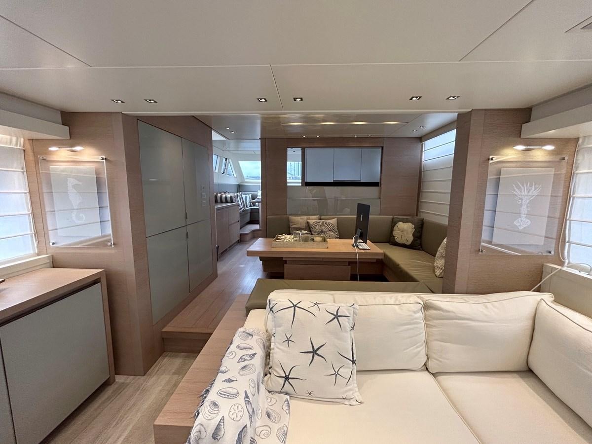 a living room with a couch and a table aboard KIND OF BLUE Yacht for Sale