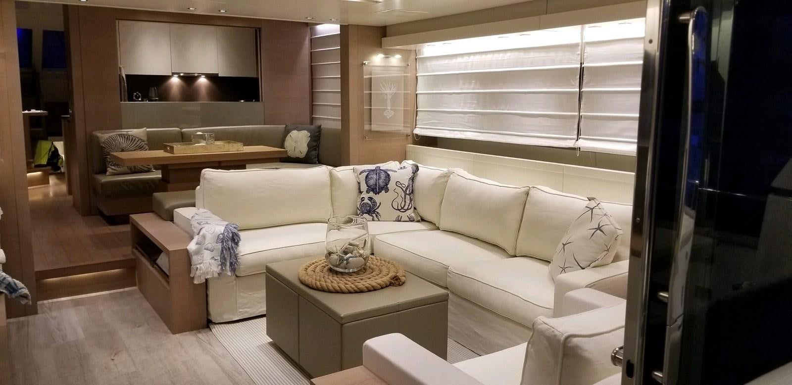a living room with a white couch and a coffee table aboard KIND OF BLUE Yacht for Sale