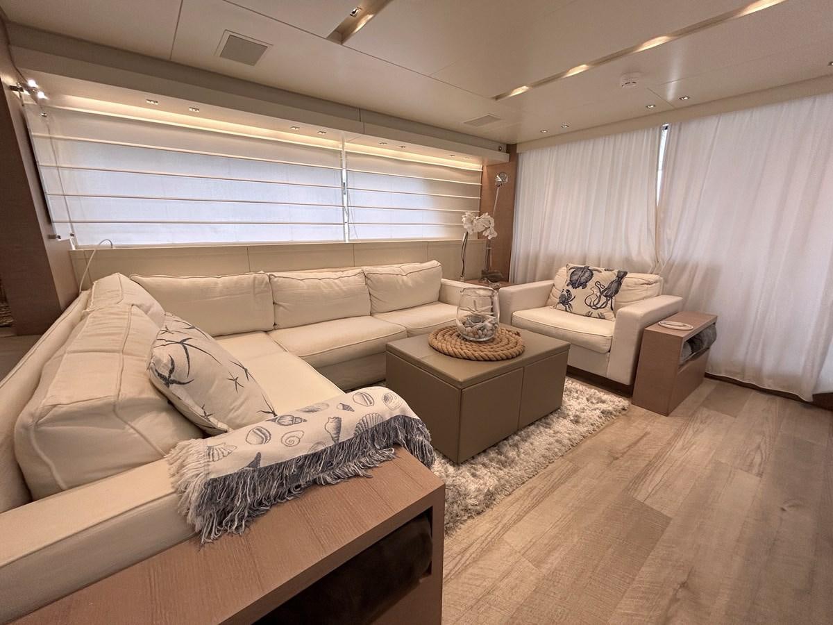 a living room with a couch and a table aboard KIND OF BLUE Yacht for Sale