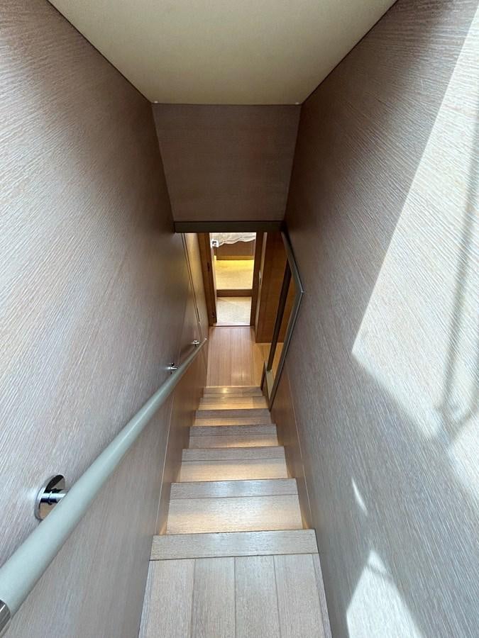 a long hallway with a door aboard KIND OF BLUE Yacht for Sale