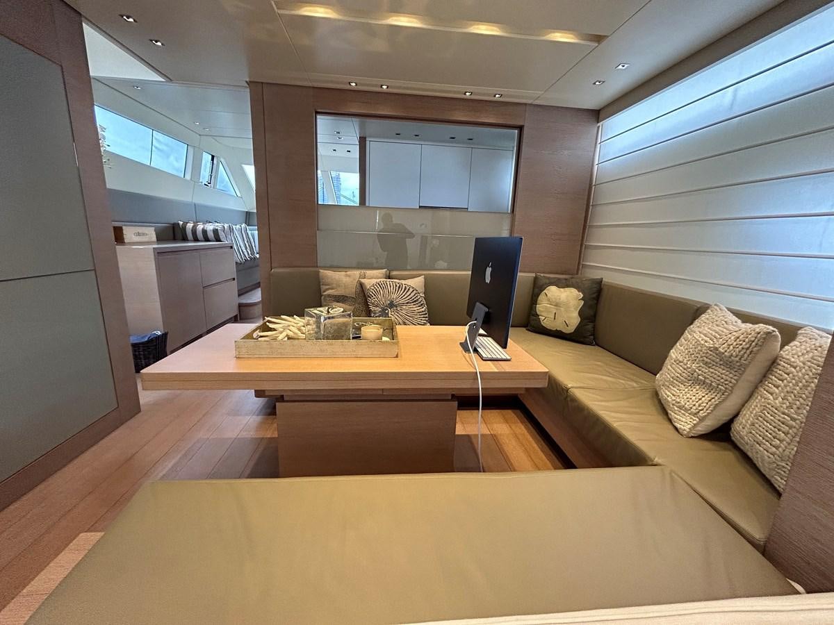 a room with a couch and a laptop on a table aboard KIND OF BLUE Yacht for Sale