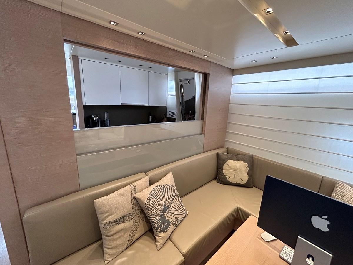 a living room with a laptop on a table aboard KIND OF BLUE Yacht for Sale