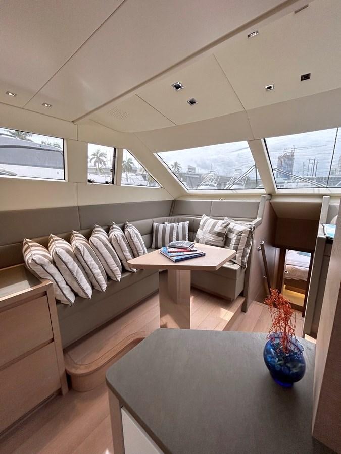 a living room with a couch and a coffee table aboard KIND OF BLUE Yacht for Sale
