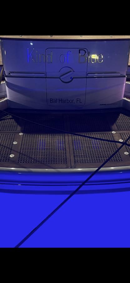 a white car with a blue stripe aboard KIND OF BLUE Yacht for Sale