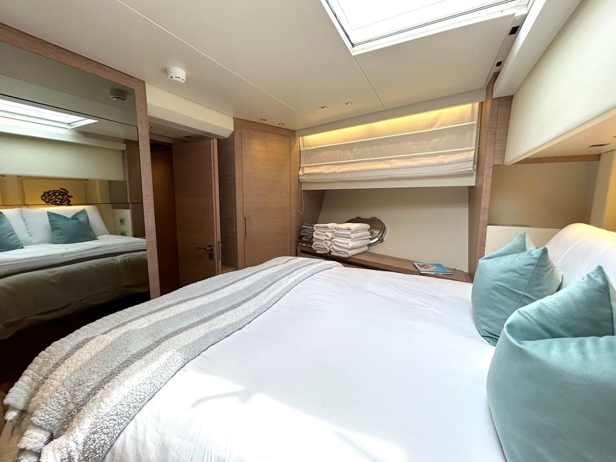 a room with a bed and a mirror aboard KIND OF BLUE Yacht for Sale
