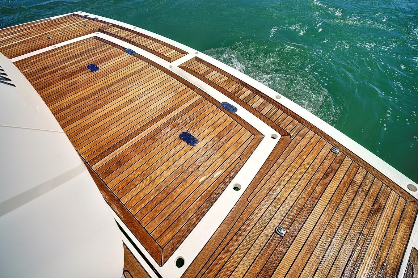 a wooden deck with a large body of water in the background aboard KING Yacht for Sale