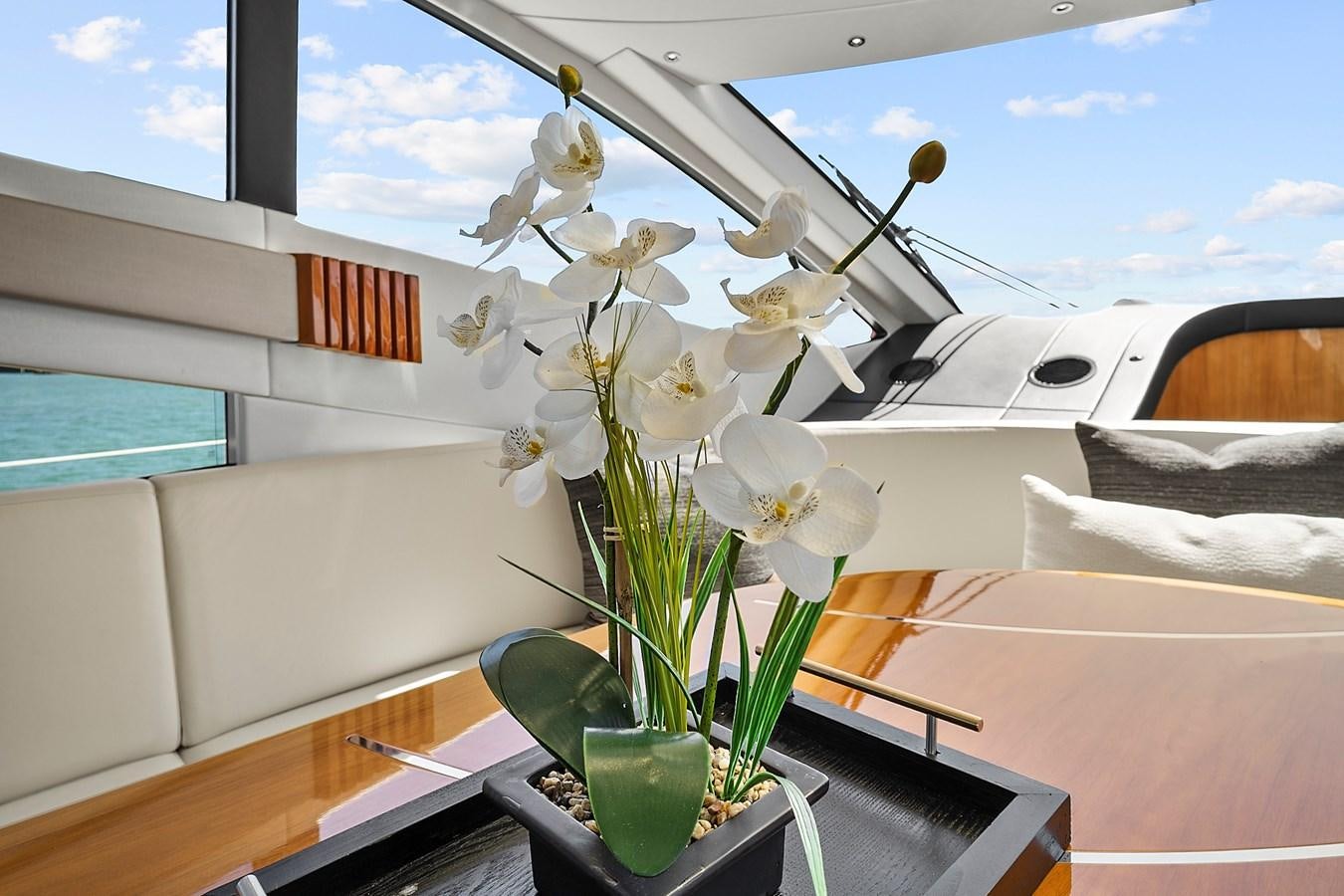a vase of white flowers on a table aboard KING Yacht for Sale