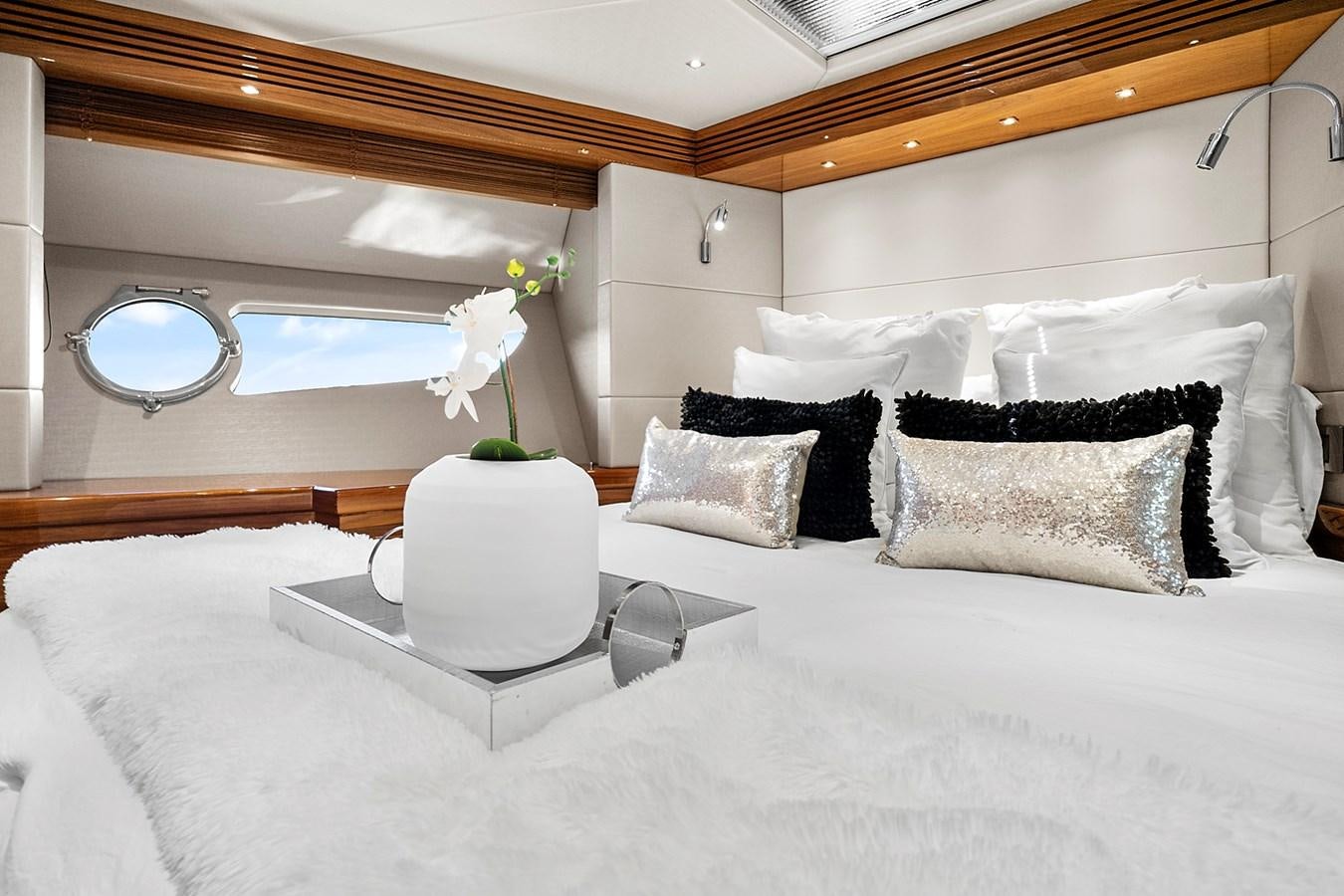 a bed with a white bed spread aboard KING Yacht for Sale