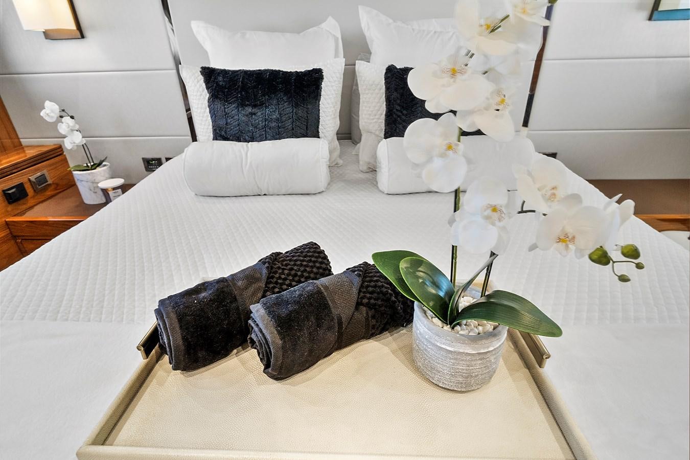 a vase of flowers on a bed aboard KING Yacht for Sale