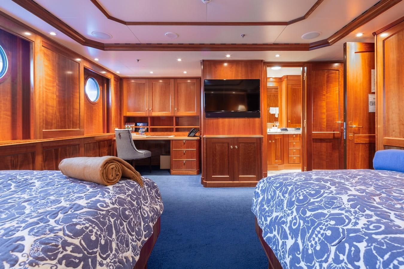 a room with a bed and a desk aboard CUPANI Yacht for Sale